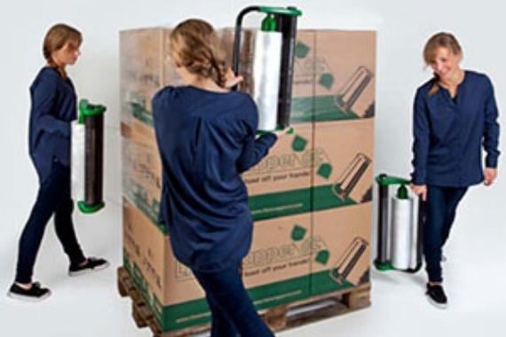 Women wrapping boxes on a pallet in pallet film
