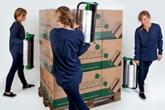 Women wrapping boxes on a pallet in pallet film