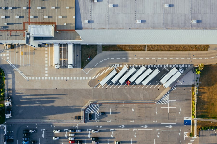 Aerial view of a distribution centre with trailers parked at its loading docks