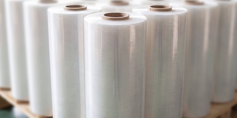 Machine stretch film rolls standing upright on a pallet