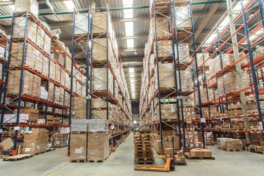 Inside of warehouse with boxes stacked to the ceiling wrapped in plastic wrap